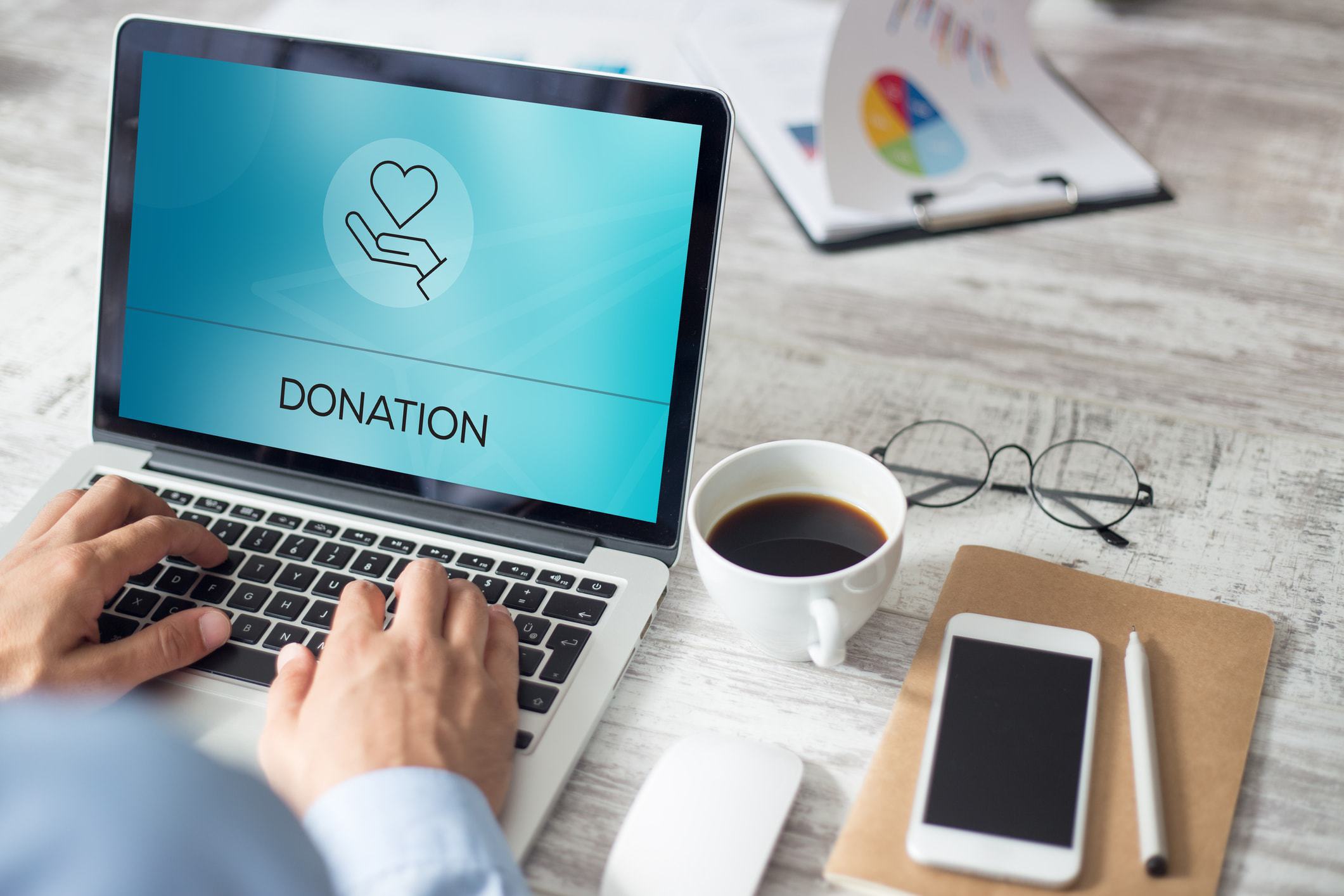 Computer screen shows the work donations with a heart icon
