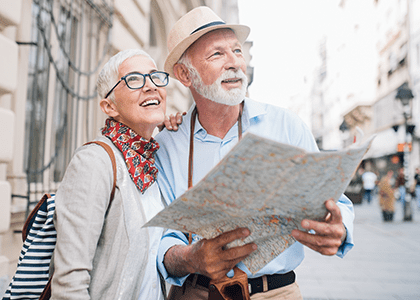 Retired couple traveling to a new city, consult a map