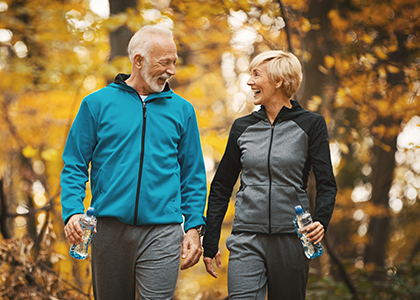 Healthy mature couple on a walk in the fall